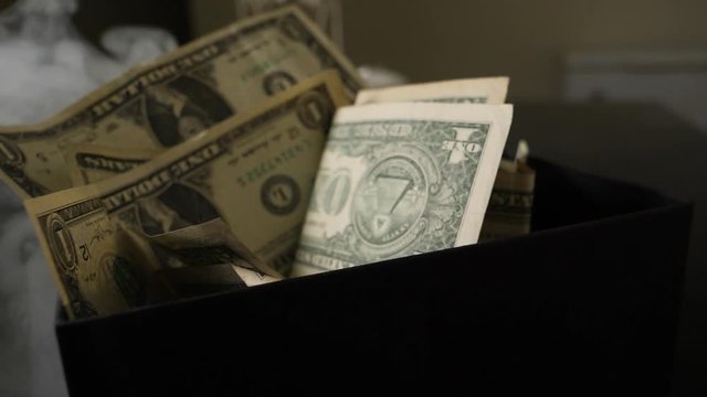 Smoke Over Dollar bills in a box, money background. Dollars money set Slow With Shallow Dof and smoke. Dollars, money close up.