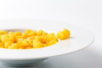 Raw elbow Macaroni (Gomiti Pasta) in bowl