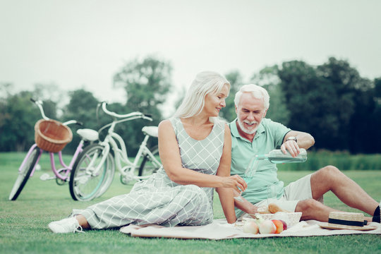 Joyful nice couple having a picnic together