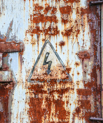 Old rustic doors with dangerous lightning sign.