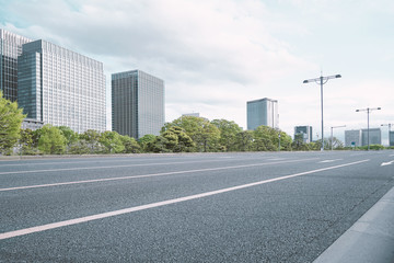Fototapeta na wymiar A group building with tree and road in a modern city in Tokyo. - Image