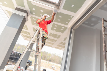 Construction worker are plastered a ceiling. Concept build a house