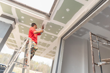 Construction worker are plastered a ceiling. Concept build a house