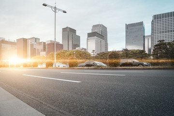 A group building with tree and road in a modern city in Tokyo. - Image