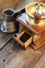 Coffee grinder, turk  of coffee on wooden background