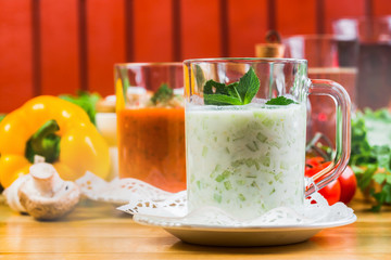 homemade zucchini creamy soup  in mug on a light background