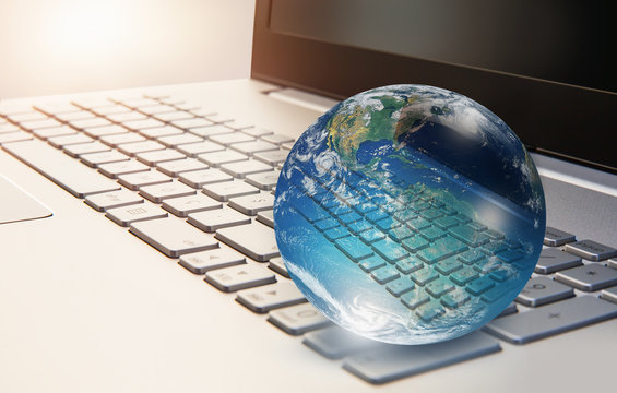 Glass globe on laptop keyboard "Elements of this image furnished by NASA " 