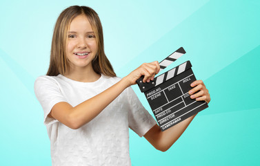 Happy smiling girl portrait holding clapper board