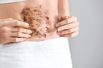 Young woman with body scrub on her belly, closeup