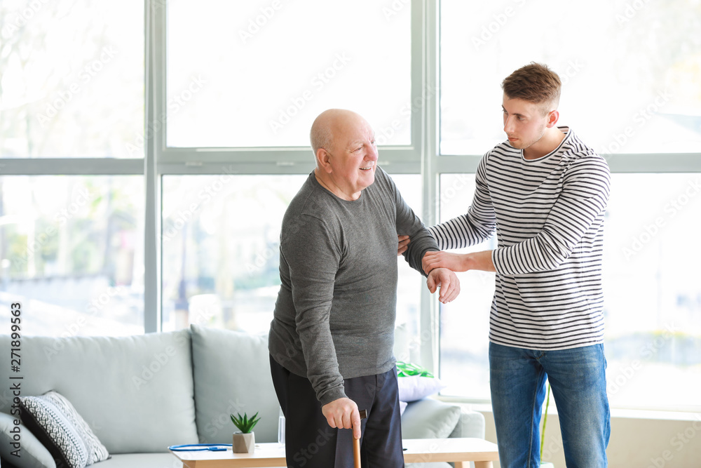 Poster Male caregiver with senior man in nursing home