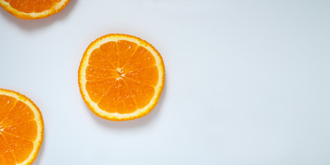 sliced orange on light blue background with space for recording
