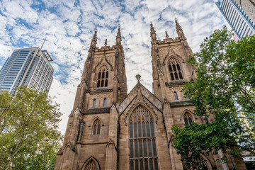 Fototapeta premium The Western Towers of Sydney's St Andrew's Cathedral against a dramatic sky, Australia
