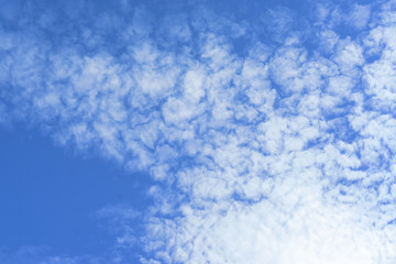 Beautiful view of white fluffy clouds on a clear blue sky background. Nature weather on the vast cloud blue sky. Sky daylight in summer. Natural background with copy space. Element of design.