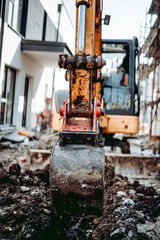 Fototapeta na wymiar Close up details of excavator scoop digging on construction site