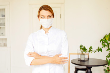 Friendly young female doctor in uniform in medical office