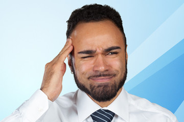 Young african-american businessman suffering from headache after hard working day