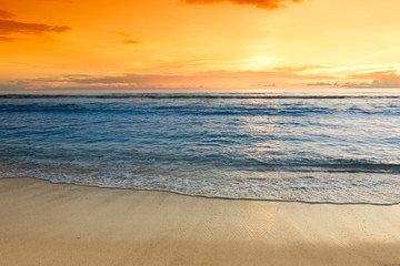 Fototapeta na wymiar Sunset over sandy ocean beach