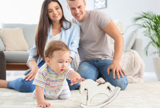 Happy Parents With Cute Little Baby At Home