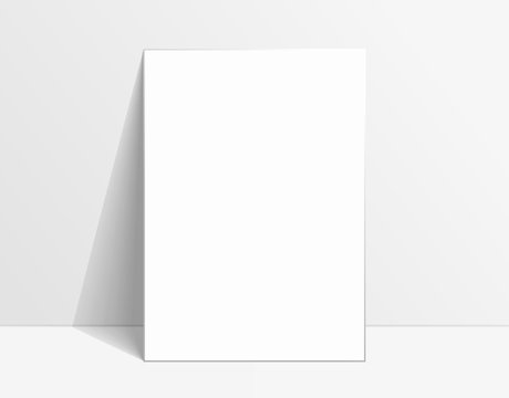 White poster mockup standing on the floor near white wall. Blank Canvas Mockup for design