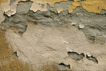 old white wall with cracked plaster and paint
