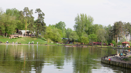 Fototapeta na wymiar Beautiful view of the fishing pond with gazebos