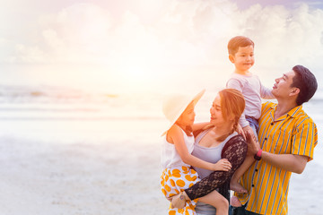 Group of Asian family happiness holiday summer together at sea beach