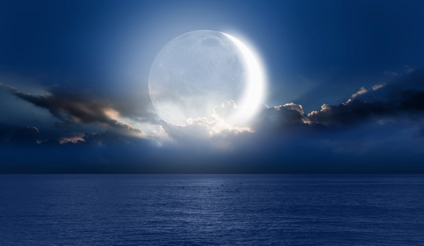 Night sky with moon in the clouds "Elements of this image furnished by NASA