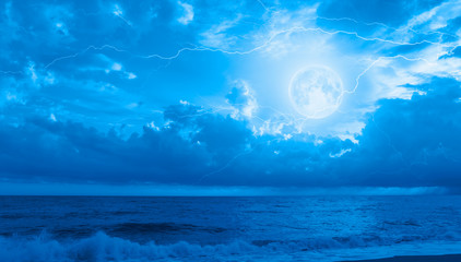 Night sky with full moon in the clouds on the background lightning "Elements of this image furnished by NASA