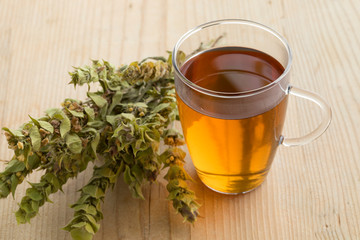  Glass of tea with twigs of dried green ironwort