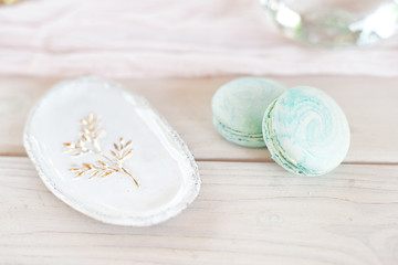 Sweet french macaroons on wood flat lay copyspace. Top voew on set of three purple macaroons on wooden board, lying diagonally on wooden table, void