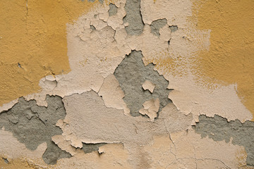 old white wall with cracked plaster and paint