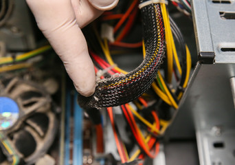 Inside details of the old personal computer. Cooler, motherboard, wires and video card in the dust....