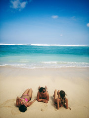 Naklejka na ściany i meble Friends enjoying on a sandy tropical ocean / sea beach.