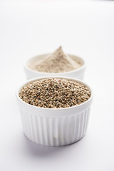 Bajra (pearl millet) / sorghum grains with it's flour or powder in a bowl, selective focus