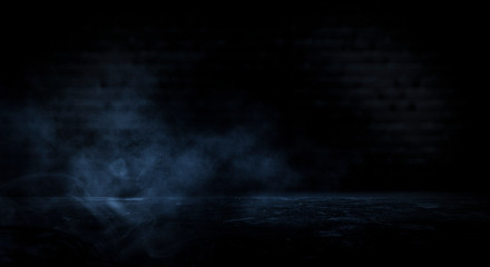Dark empty scene, blue neon searchlight light, wet asphalt, smoke, night view, rays. Empty black studio room. Dark background. Abstract dark empty studio room texture.  Product showcase spotlight back