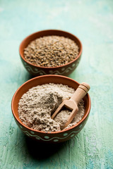Bajra (pearl millet) / sorghum grains with it's flour or powder in a bowl, selective focus
