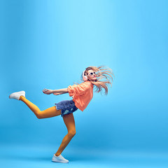 Young easy-going happy hipster Woman dance Having Fun in Stylish fashion headphones. Beautiful...