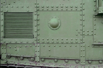 Texture of tank side wall, made of metal and reinforced with a multitude of bolts and rivets