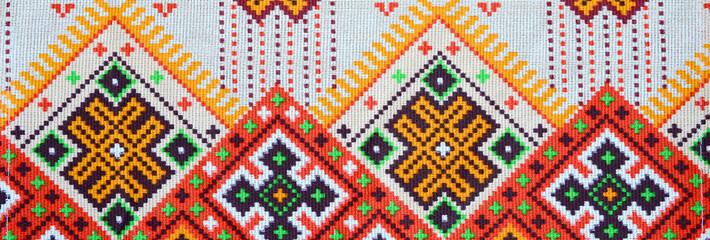 Traditional Ukrainian folk art knitted embroidery pattern on textile fabric
