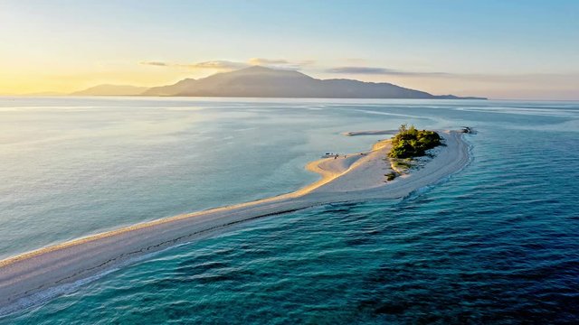 Epic aerial view of tropical island at sunset