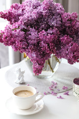 cup of coffee and flowers on table