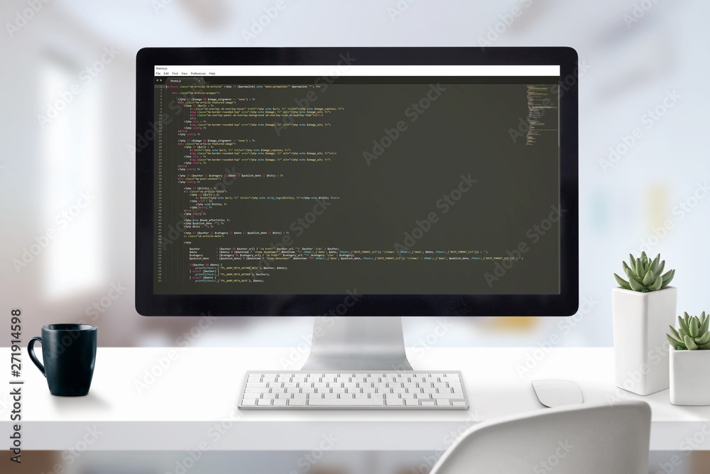 Poster Web developer computer with javascript code on display. Work desk close-up scene with office in background.