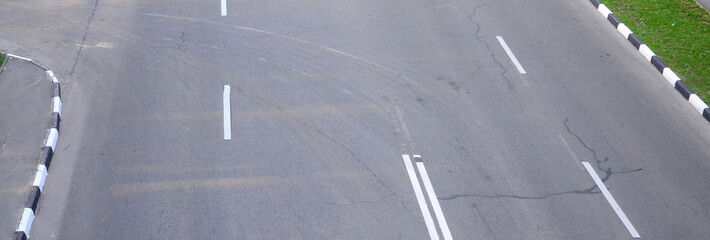 Damaged bad asphalt road with potholes. Patch repair of asphalt