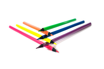 Back to school background with neon colors pencils on white backdrop, isolated. Flat lay, top view, copy space. Creative concept.