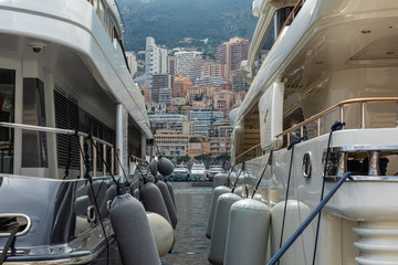 Yachts docked at Port Hercules in La Condamine harbour. Cityscape of Monte Carlo. Principality of Monaco..