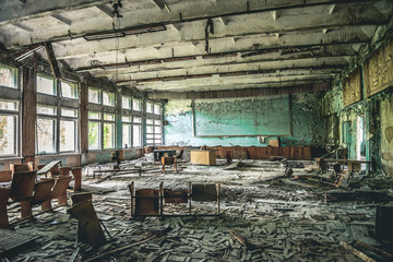 ruined assembly hall with debris in abandoned Pripyat school