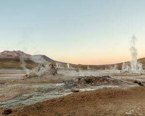 Erupting Hot Geyser Of Steam in El Tatio Geysers field at early morning sunrise, Atacama desert, Chile