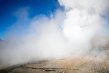 Erupting Hot Geyser Of Steam in El Tatio Geysers field at early morning sunrise, Atacama desert, Chile