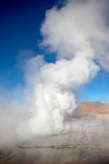 Erupting Hot Geyser Of Steam in El Tatio Geysers field at early morning sunrise, Atacama desert, Chile
