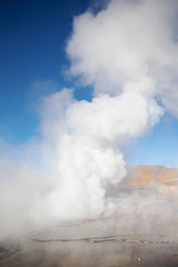 Erupting Hot Geyser Of Steam in El Tatio Geysers field at early morning sunrise, Atacama desert, Chile